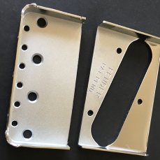 Genuine Fender bridge plate sawn in two